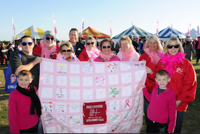 FA members posing with the FA created breast cancer quilt