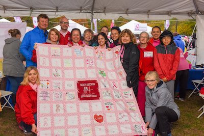 FA members and friends display the handmade FA breast cancer quilt