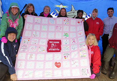 Team FA holds the FA's breast cancer quilt